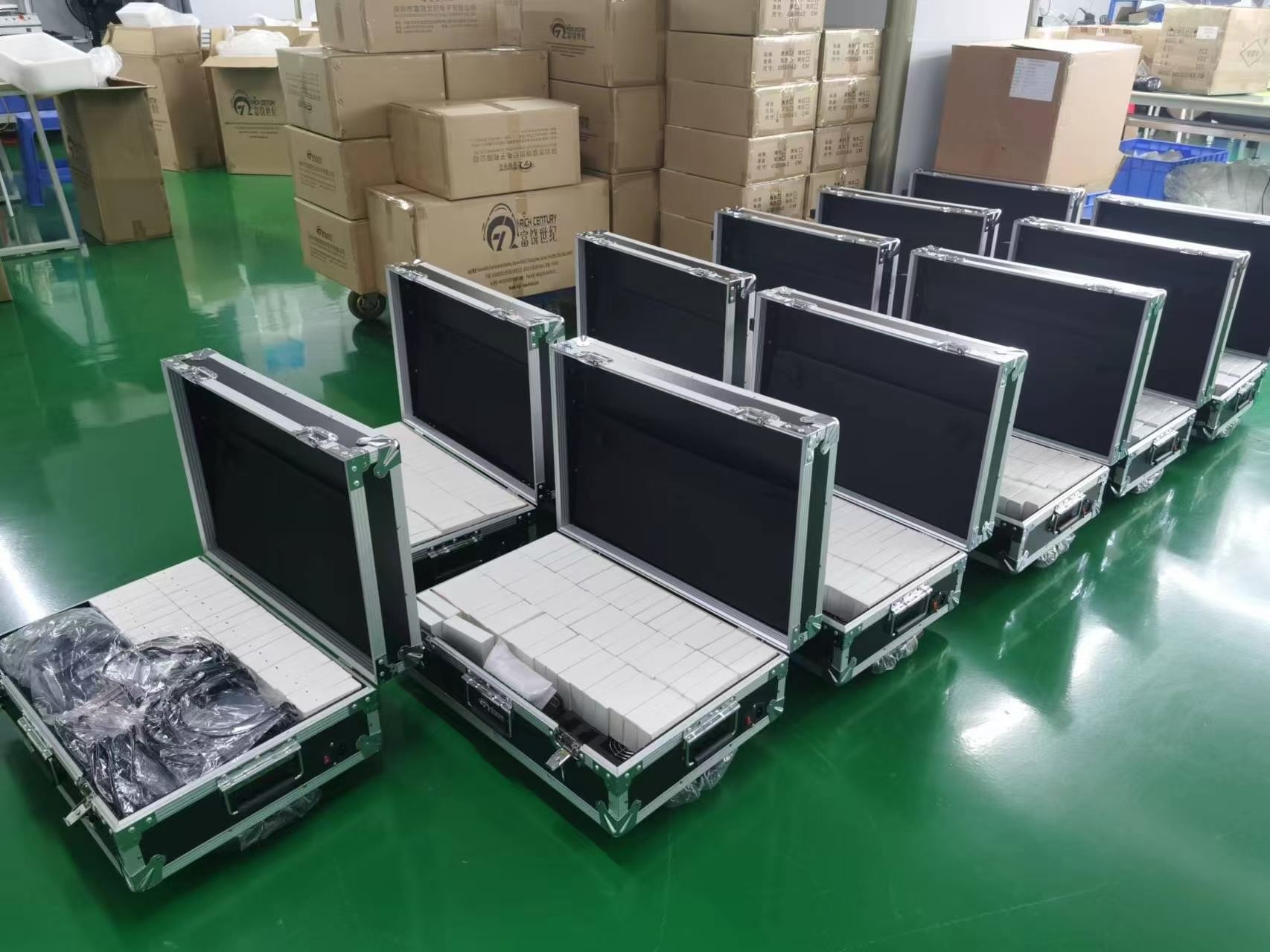 RC2406 charging cases filled with labeled receivers lined up on a depot floor RC2406 charging cases filled with labeled receivers lined up on a depot floor