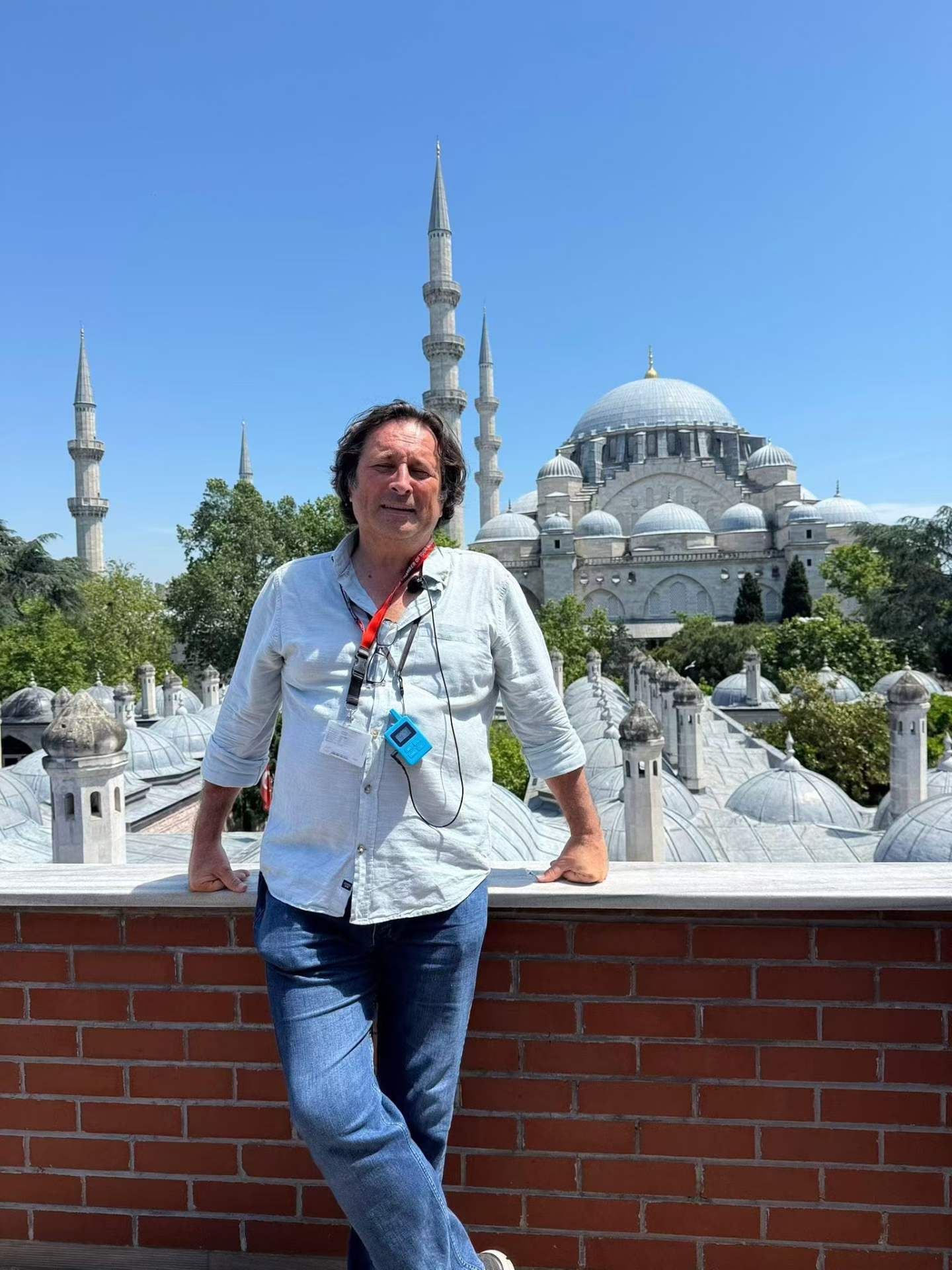 A tour guide holding the transmitter with its neck strap during an Istanbul mosque visit A tour guide holding the transmitter with its neck strap during an Istanbul mosque visit